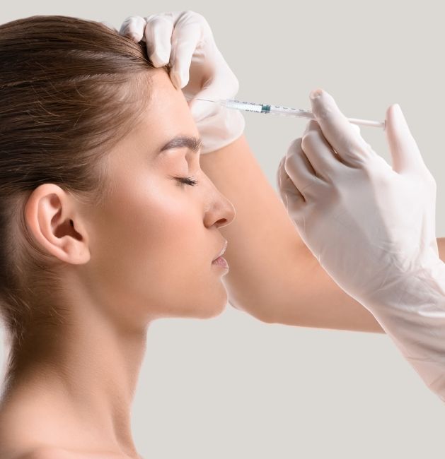 Woman getting injection in her forehead