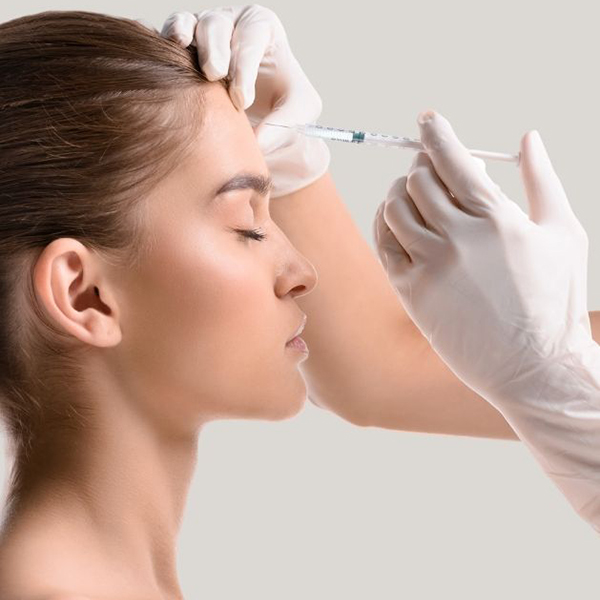 Woman getting injection in her forehead