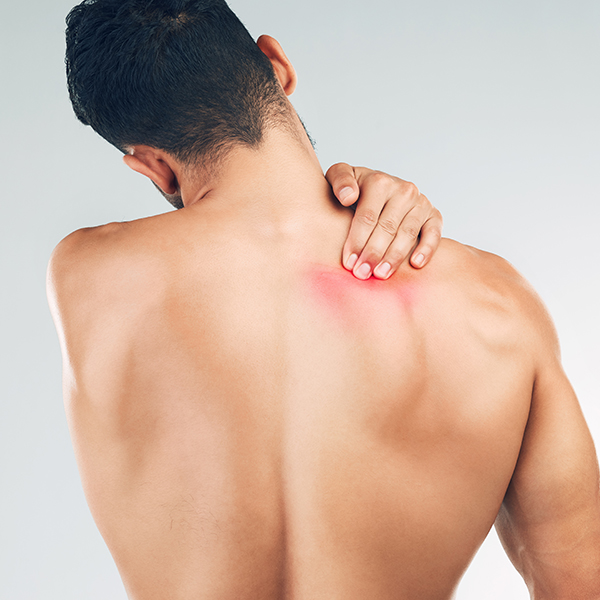 man holding his shoulder with back pain