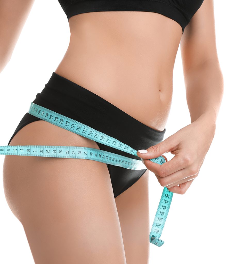 Woman measuring her waist with tape measure
