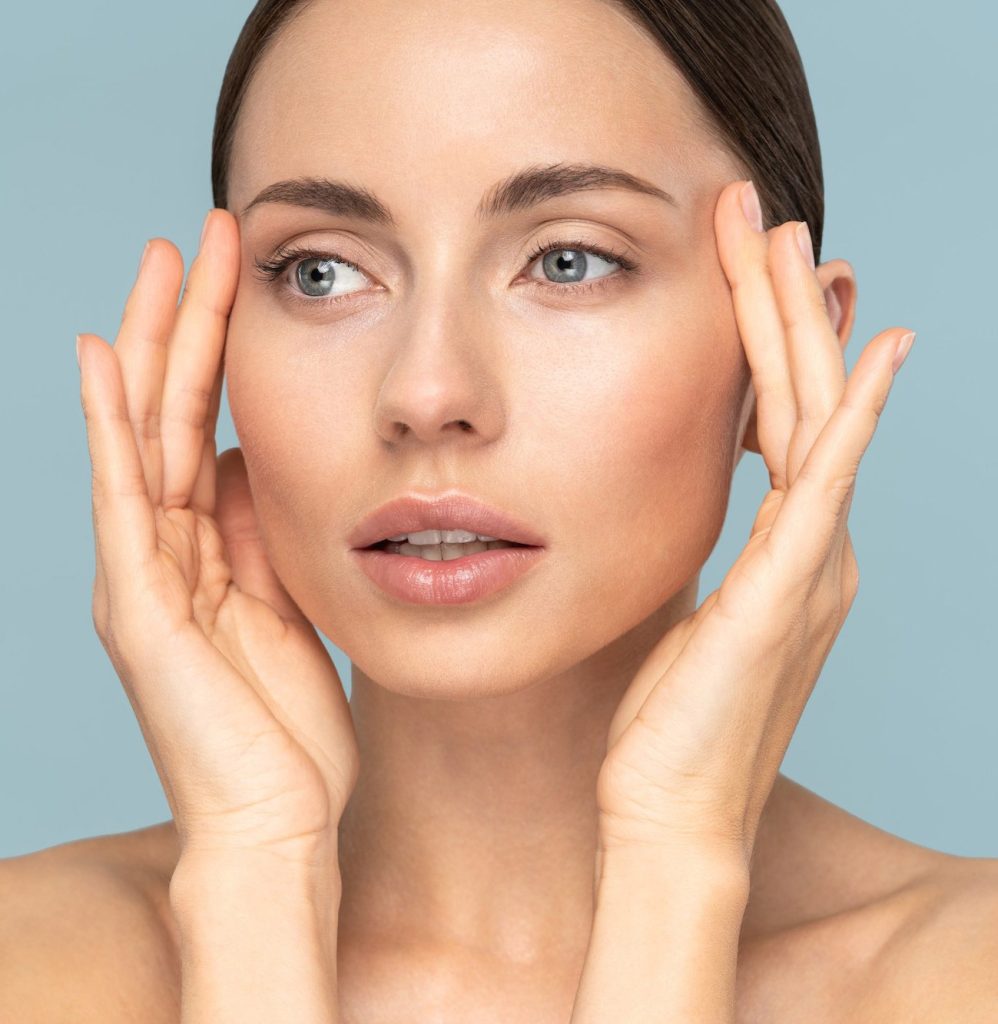 Woman with her hands up next to her eyes